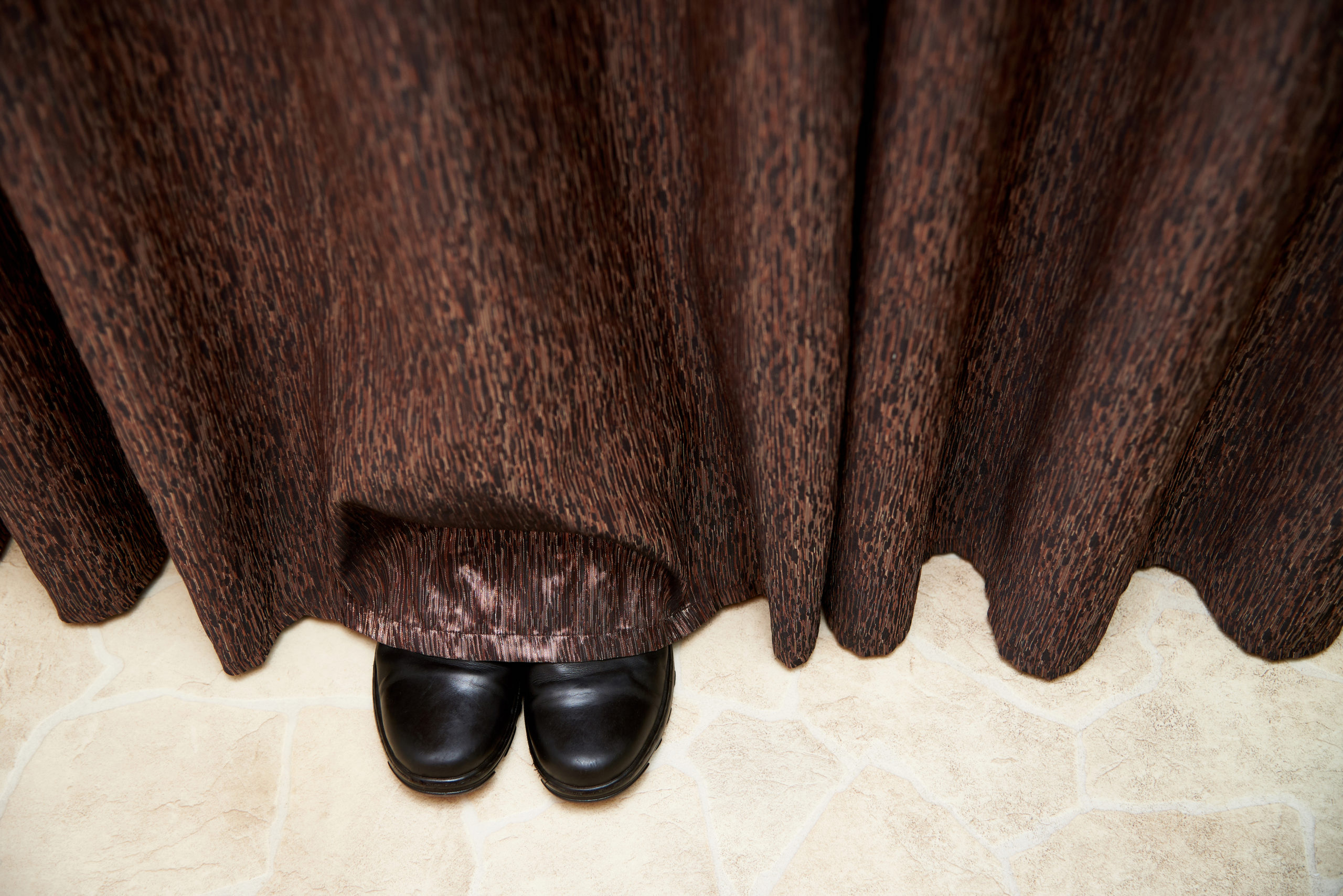 Boots stick out from under the curtains